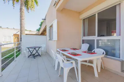 a patio with a table and chairs on a balcony at La Perla di Santa Maria - Vue mer, plage à 100 m in Santa-Maria-Poggio
