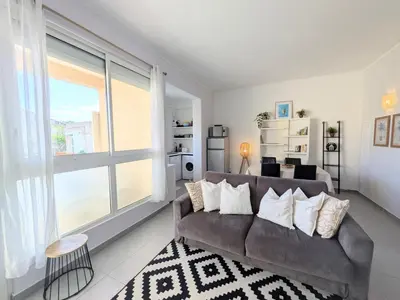a living room with a couch and a large window at La Perla di Santa Maria - Vue mer, plage à 100 m in Santa-Maria-Poggio
