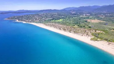 an aerial view of a beach and the ocean at Villa Gaïa, 6 pers, piscine chauffée, 3 min plage in Sainte-Lucie de Porto-Vecchio