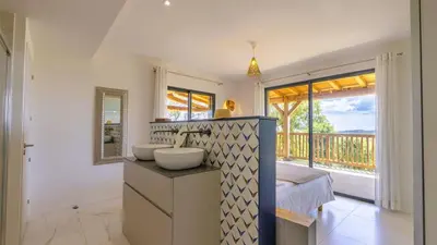 a bathroom with two sinks and a large window at Villa Gaïa, 6 pers, piscine chauffée, 3 min plage in Sainte-Lucie de Porto-Vecchio