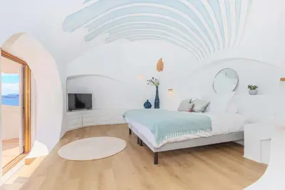 a white bedroom with a bed and a tv at Villa Puccinelli in Porto-Vecchio