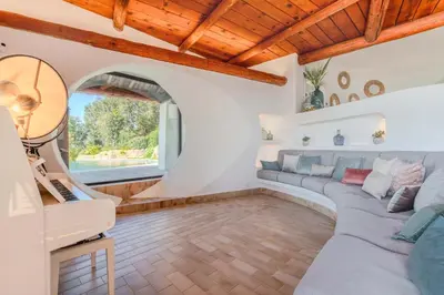 a living room with a couch and a table at Villa Puccinelli in Porto-Vecchio