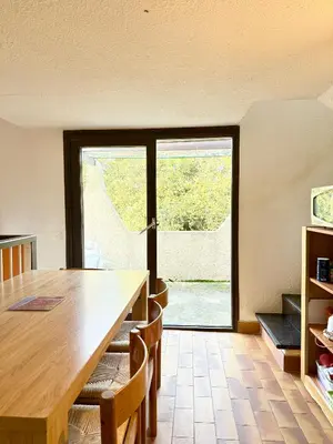 a dining room with a table and a large window at Maisonnette vue mer résidence vacances Porticcio in Grosseto-Prugna