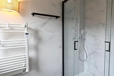 a bathroom with a shower with a glass door at Casa 115 - Plage & piscine chauffée in Pianottoli-Caldarello
