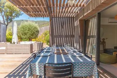 a table with a blue table cloth on a patio at A Casedda Serena Di lecci in San-Gavino-di-Carbini