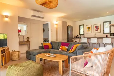 a living room with a couch and a table at A Casedda Serena Di lecci in San-Gavino-di-Carbini