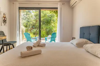 a bedroom with a bed with two towels on it at Casa Di Sole Di Pinarello in Pinarellu