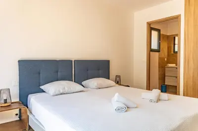 a bedroom with a large bed with towels on it at Casa Di Sole Di Pinarello in Pinarellu