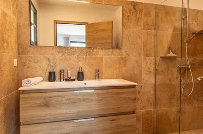 a bathroom with a sink and a mirror at Casa Di Sole Di Pinarello in Pinarellu