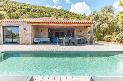 a villa with a swimming pool and a patio at Casa Di Sole Di Pinarello in Pinarellu