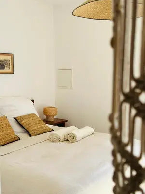 a bedroom with a bed and a large window at VISTA CORSICA saison #2 vue à couper le souffle in Sotta