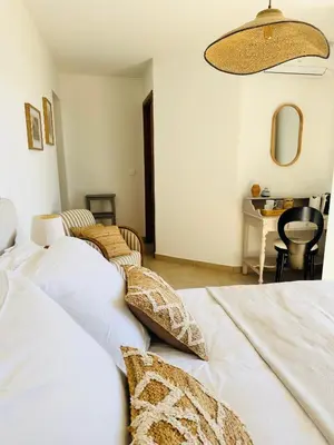 a bedroom with a bed and a lamp and a plant at VISTA CORSICA saison #2 vue à couper le souffle in Sotta