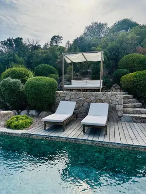 a deck with two chairs and a gazebo next to the water at VISTA CORSICA saison #2 vue à couper le souffle in Sotta