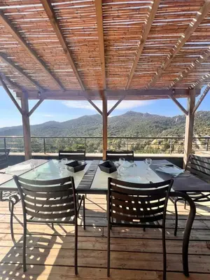 a table and chairs on a deck with a view at Duplex Vista in Bonifacio