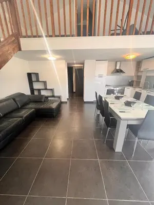 a living room with a couch and a table at Duplex Vista in Bonifacio