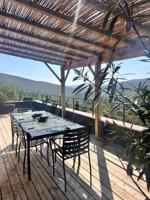 a table and chairs on a deck with a view at Duplex Vista in Bonifacio