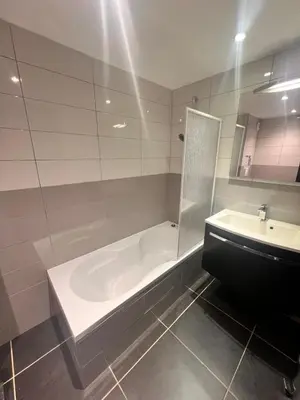 a bathroom with a bath tub and a sink at Duplex Vista in Bonifacio
