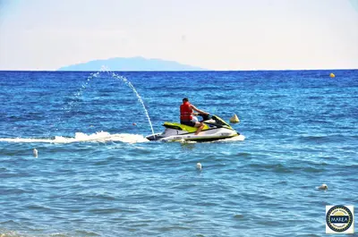 two people on a jet ski in the water at Bungalow on the sea - Moriani beach in Santa-Lucia-di-Moriani