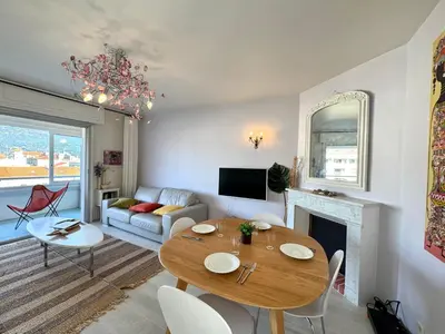 a living room with a table and a fireplace at Appartement vue sur les toits de Propriano in Propriano