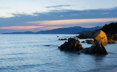 a view of the ocean with rocks in the water at Villa SOLEIL in Figari