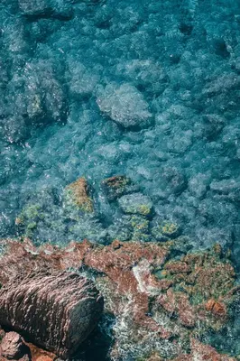 a view of the ocean with rocks and water at Villa SOLEIL in Figari