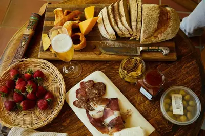 a table with a tray of food and a plate of fruit at Villa SOLEIL in Figari