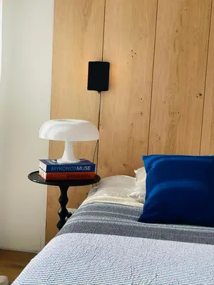 a bedroom with a bed and a table with a lamp at Appartement Marinella route des Sanguinaires Corse in Ajaccio