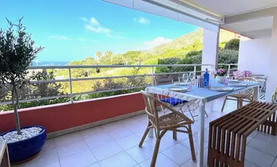 a balcony with a table and chairs and a view at Appartement Marinella route des Sanguinaires Corse in Ajaccio