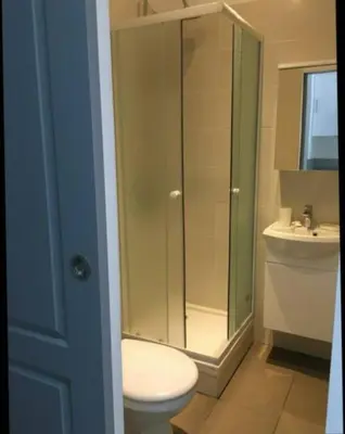a bathroom with a shower and a toilet and a sink at studio centre ville in Ajaccio