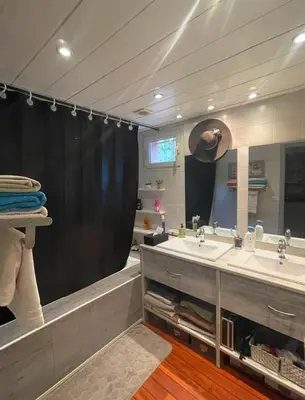 a bathroom with two sinks and a large mirror at Pépite du Maquis in Porto-Vecchio