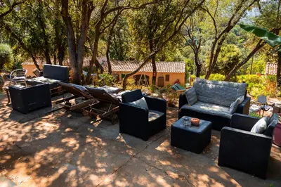 a patio with chairs and a table at Domaine de la Testa in Sainte-Lucie de Porto-Vecchio