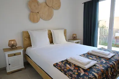 a bedroom with a bed with two towels on it at I Tramizzi - Maison 3 Chambres à Bonifacio in Bonifacio