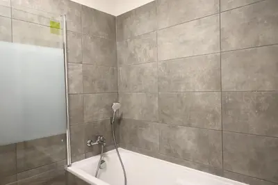 a bathroom with a shower with a bath tub at I Tramizzi - Maison 3 Chambres à Bonifacio in Bonifacio
