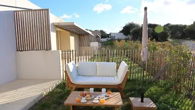 a chair and a table with food on a patio at I Tramizzi - Maison 3 Chambres à Bonifacio in Bonifacio