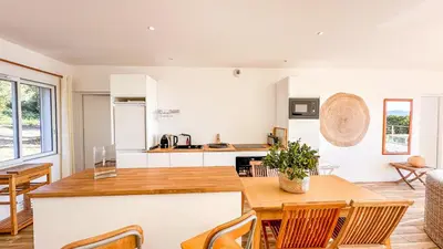 a kitchen and dining room with a table and chairs at Casa Luna Di Santa Lucia in Sainte-Lucie de Porto-Vecchio