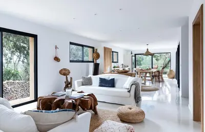 a living room with a white couch and a table at Villa Grazie in Bonifacio