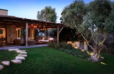 a backyard with a house with a lawn at Villa Grazie in Bonifacio