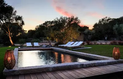 a pool in a yard with lounge chairs next to it at Villa Grazie in Bonifacio