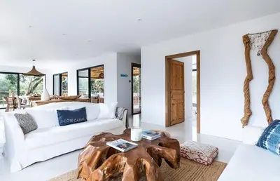 a living room with a white couch and a wooden table at Villa Grazie in Bonifacio