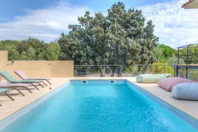 a swimming pool with two lounge chairs and a swimming pool at Villa Mathilda Di Porto-Vecchio in Lecci