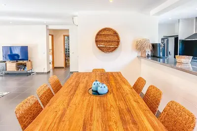 a dining room with a wooden table and chairs at Villa Mathilda Di Porto-Vecchio in Lecci