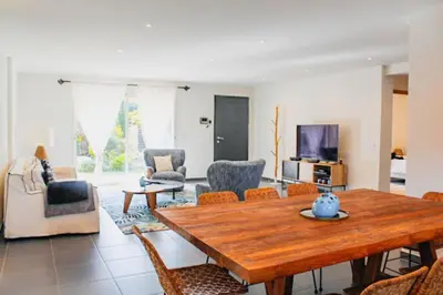 a living room with a wooden table and chairs at Villa Mathilda Di Porto-Vecchio in Lecci