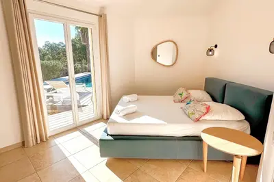 a room with a couch and a table and a window at Villa Capanaccia Di Arasu in Sainte-Lucie de Porto-Vecchio