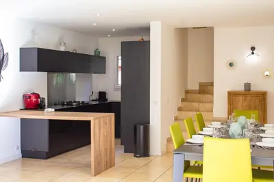 a kitchen and dining room with a table and chairs at Villa Belladona Di Arasu in Sainte-Lucie de Porto-Vecchio