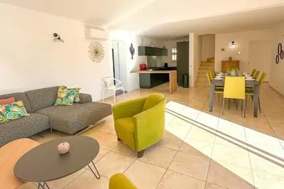 a living room with a couch and chairs and a table at Villa Belladona Di Arasu in Sainte-Lucie de Porto-Vecchio