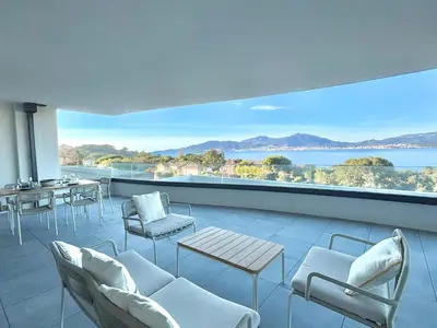 a room with chairs and tables and a large window at Appartement vue mer Royal Palm Porticcio in Porticcio