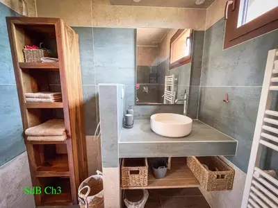 a bathroom with a sink and a mirror at A l'Orée du Maquis Villa 6 personnes in Bonifacio