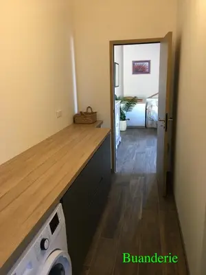 a kitchen with a washer and dryer in a room at A l'Orée du Maquis Villa 6 personnes in Bonifacio