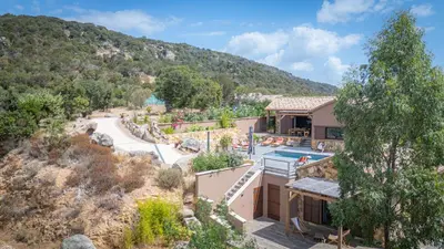 an aerial view of a house with a mountain at A l'Orée du Maquis Villa 6 personnes in Bonifacio