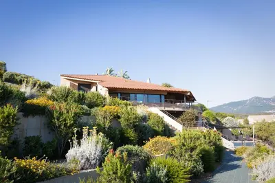 a house on top of a hill with plants at AZUR E CASTELLU - CORSE SUD - Pied à terre IDEAL in Calcatoggio